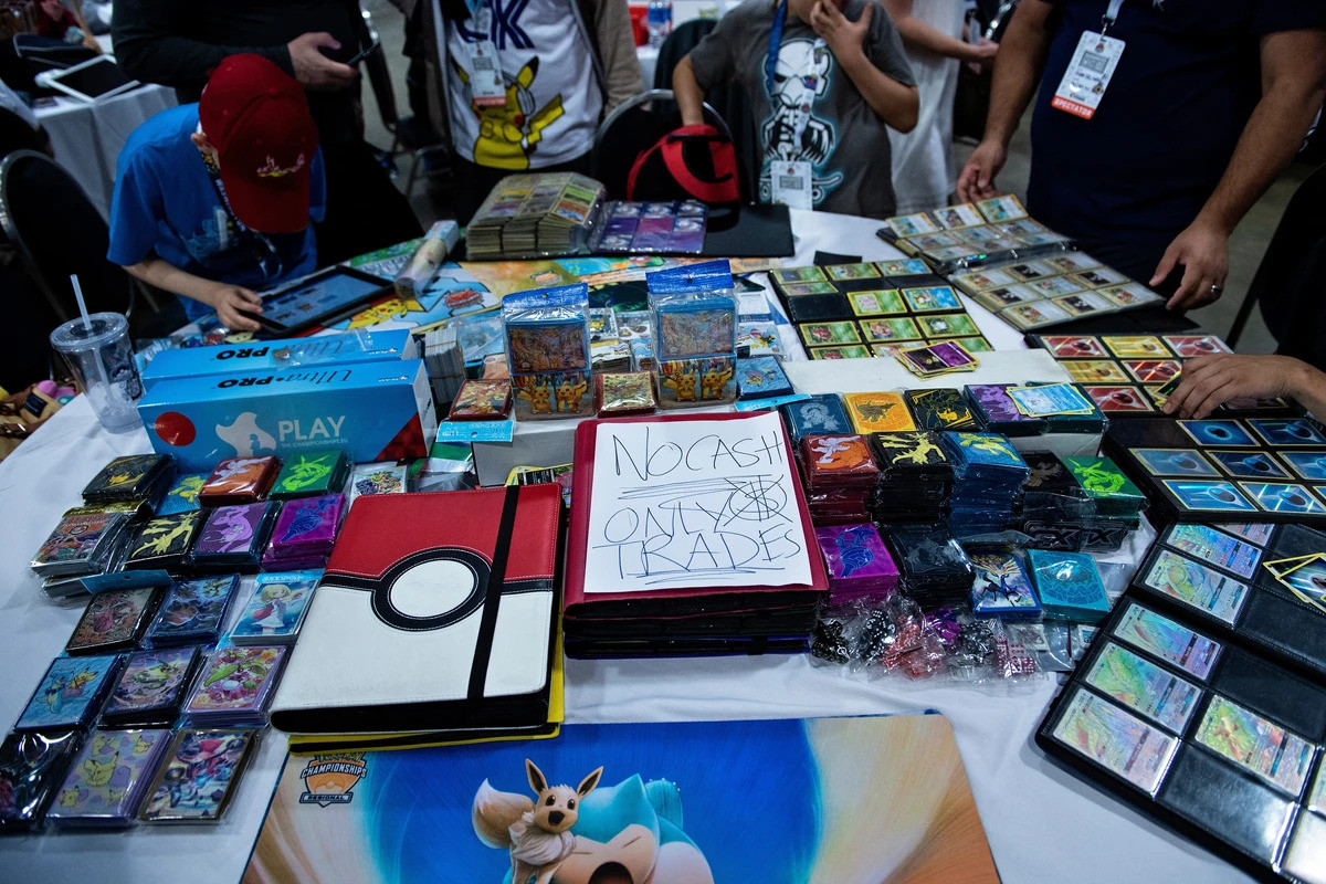 People trade Pokemon cards during the first day of the 2019 Pokemon World Championships at the Washington Convention Center. AP