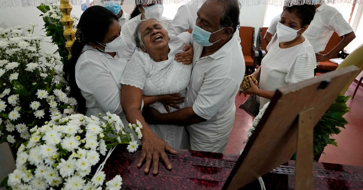 Diyawadana's mother grieves at her son's coffin after his body was returned to Sri Lanka. Photo: Eranga Jayawardena/AP