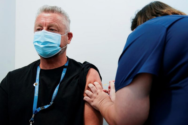 a healthcare professional administers a dose of the pfizer coronavirus disease covid 19 vaccine to dr chris quinn as high risk workers receive the first vaccines in the state of victoria s rollout of the program in melbourne australia february 22 2021 photo reuters a healthcare professional administers a dose of the pfizer coronavirus disease covid 19 vaccine to dr chris quinn as high risk workers receive the first vaccines in the state of victoria s rollout of the program in melbourne australia february 22 2021 photo reuters