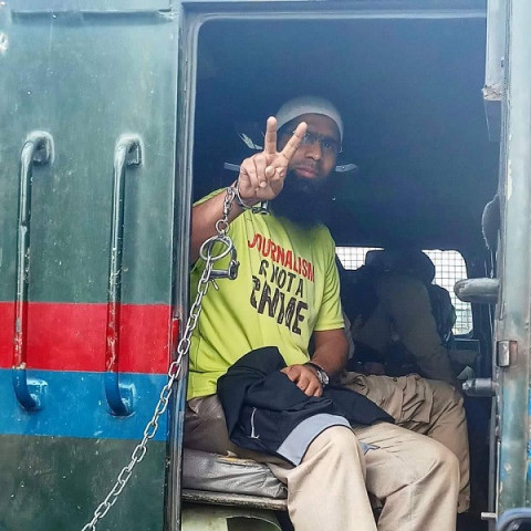 aasif sultan seen gesturing from the police vehicle outside a srinagar court photo x cpjasia aasif sultan seen gesturing from the police vehicle outside a srinagar court photo x cpjasia