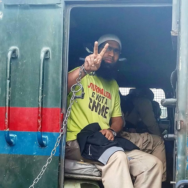 aasif sultan seen gesturing from the police vehicle outside a srinagar court photo x cpjasia