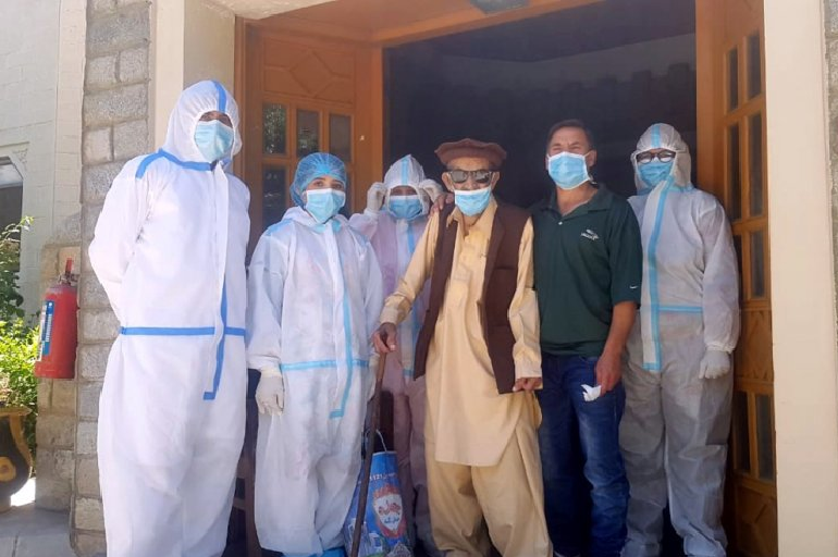 Abdul Alim, 103, stands with his son Suhail Aziz and staff members wearing PPE in this group photograph taken after he recovered from coronavirus. PHOTO: REUTERS