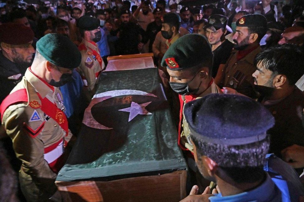 Pakistan Army soldiers hold AQ Khan's flag-draped coffin during his funeral in Islamabad. PHOTO: AFP
