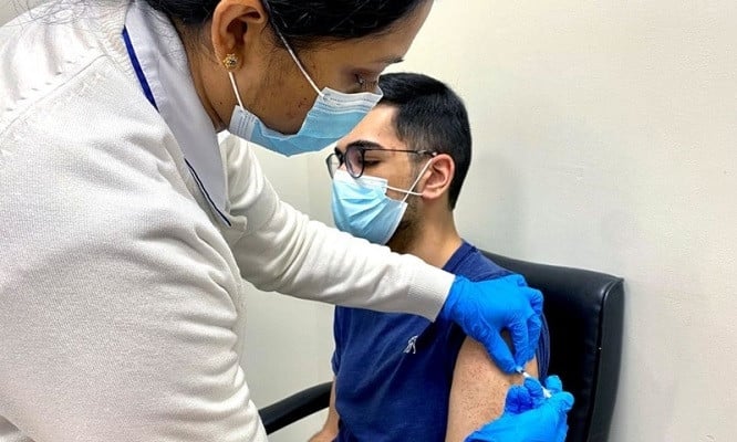 a man receives a dose of a vaccine against the coronavirus disease covid 19 in dubai united arab emirates december 28 2020 photo reuters