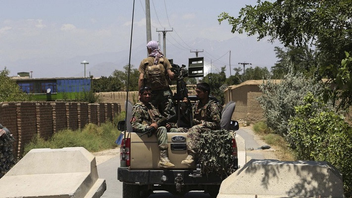 afghan national army ana soldiers stand guard at the back of a vehicle at a road checkpoint outside bagram air base after all us and nato troops left some 70 km north of kabul on july 2 2021 photo afp