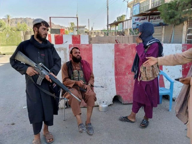 taliban fighters stand guard at a check point in farah afghanistan august 11 2021 photo reuters taliban fighters stand guard at a check point in farah afghanistan august 11 2021 photo reuters