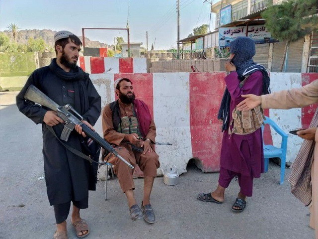 taliban fighters stand guard at a check point in farah afghanistan august 11 2021 photo reuters