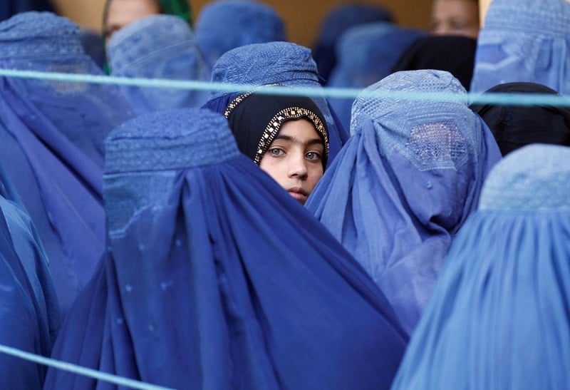 a girl looks on among afghan women lining up to receive relief assistance in jalalabad afghanistan june 11 2017 photo reuters
