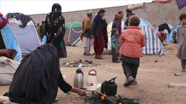 afghan families who had to migrate to the province of herat due to the ongoing conflicts between the taliban and the previous government forces in afghanistan live in summer camp tents which were overturned by cold strong winds and covered in mud by the rain in herat afghanistan on january 16 2022 photo anadolu agency