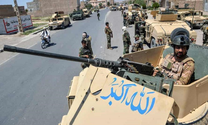 an afghan national army commando stands guard on a vehicle in herat province on sunday photo afp