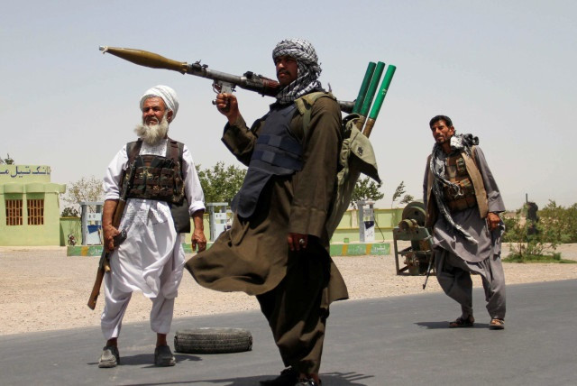 Former Mujahideen hold weapons to support Afghan forces in their fight against Taliban, on the outskirts of Herat province, Afghanistan July 10, 2021. PHOTO: REUTERS