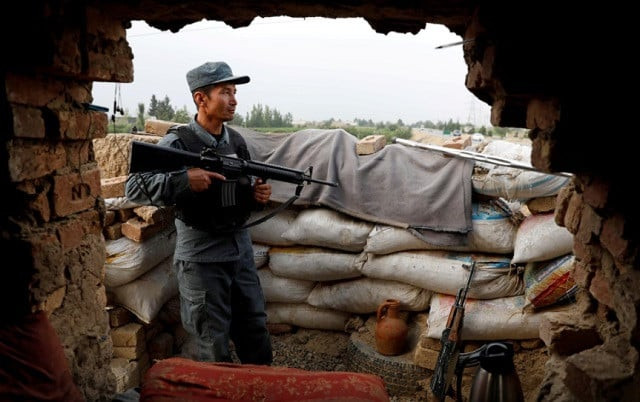 an afghan policeman keeps watch at the check post on the outskirts of kabul afghanistan july 13 2021 photo reuters an afghan policeman keeps watch at the check post on the outskirts of kabul afghanistan july 13 2021 photo reuters
