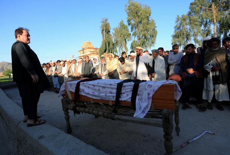 men pray in front of the coffin of one of three female polio vaccination health workers who were shot and killed by unknown gunmen at two separate locations in jalalabad afghanistan march 30 2021 photo reuters