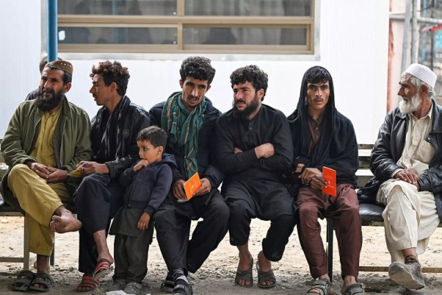 afghan refugees waiting for their turn at the united nations high commissioner for refugees unhcr centre in nowshera photo afp