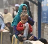 afghan refugee children sit outside the unhcr azakhel voluntary repatriation centre in nowshera photo afp