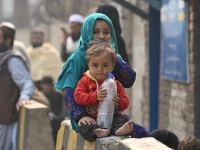 afghan refugee children sit outside the unhcr azakhel voluntary repatriation centre in nowshera photo afp
