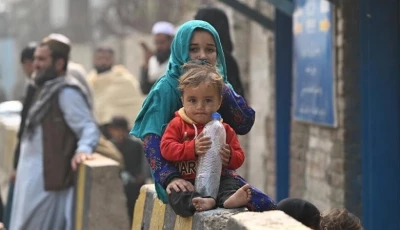 afghan refugee children sit outside the unhcr azakhel voluntary repatriation centre in nowshera photo afp