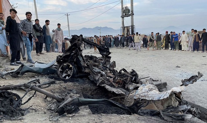 people stand at the site of a blast in kabul afghanistan may 8 2021 photo reuters