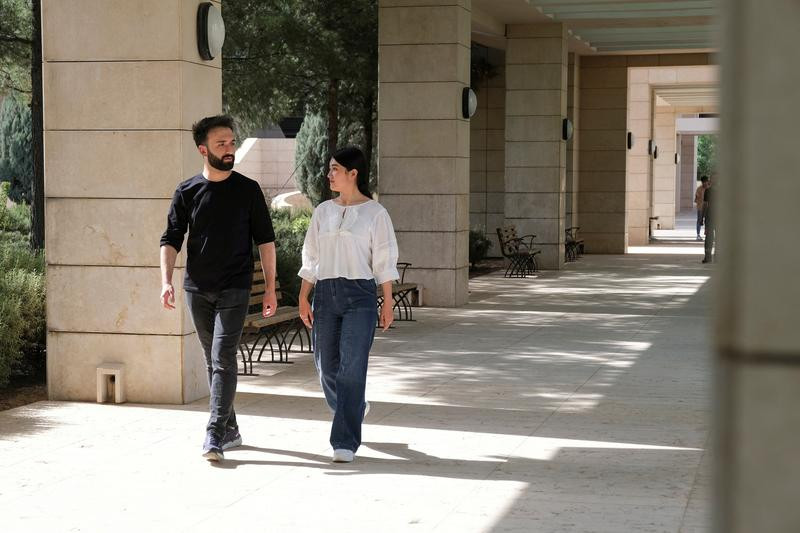 shakila mohammadi and esmatullah sahak walk at the campus of the american university in sulaimaniya while both of them left afghanistan to finish their studies sulaimaniya iraq june 14 2022 picture taken june 14 2022 photo reuters