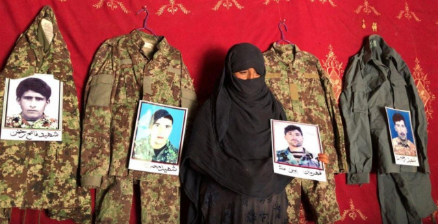taj bibi 33 holds a photo of her husband next to the military uniforms and pictures of her former husbands who were killed battling the taliban at her home in asad abad kunar province afghanistan september 20 2020 photo reuters taj bibi 33 holds a photo of her husband next to the military uniforms and pictures of her former husbands who were killed battling the taliban at her home in asad abad kunar province afghanistan september 20 2020 photo reuters