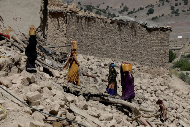 afghan women carry water containers through the debris of damaged houses after the recent earthquake in wor kali village in the barmal district of paktika province afghanistan june 25 2022 photo reuters afghan women carry water containers through the debris of damaged houses after the recent earthquake in wor kali village in the barmal district of paktika province afghanistan june 25 2022 photo reuters
