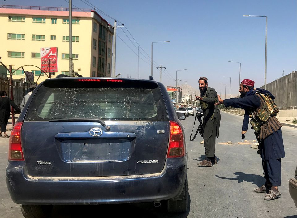 members of taliban forces gesture as they check a vehicle on a street in kabul afghanistan august 16 2021 photo reuters