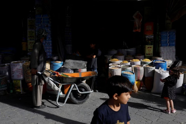 baba karim with his wheelbarrow stands next to a shop in kabul afghanistan september 3 2023 photo reuters baba karim with his wheelbarrow stands next to a shop in kabul afghanistan september 3 2023 photo reuters