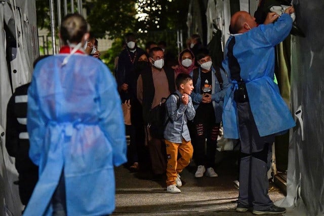 people who were evacuated from kabul afghanistan walk towards a tent to undergo coronavirus disease covid 19 testing after arriving in doberlug kirchhain germany august 20 2021 photo reuters