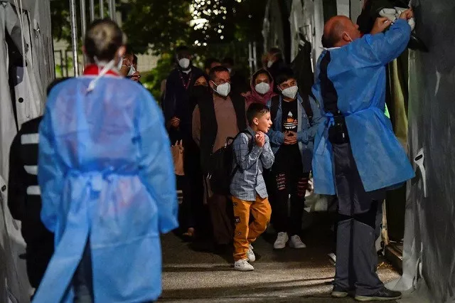 people who were evacuated from kabul afghanistan walk towards a tent to undergo coronavirus disease covid 19 testing after arriving in doberlug kirchhain germany august 20 2021 photo reuters people who were evacuated from kabul afghanistan walk towards a tent to undergo coronavirus disease covid 19 testing after arriving in doberlug kirchhain germany august 20 2021 photo reuters