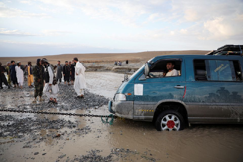 A minivan is being towed out of the flood water in the Khushi district of Logar, Afghanistan, August 21, 2022. PHOTO: REUTERS