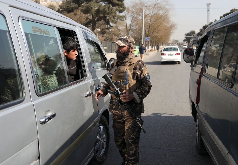 a taliban fighter searches a car as he guards a checkpoint in kabul afghanistan november 27 2021 photo reuters file