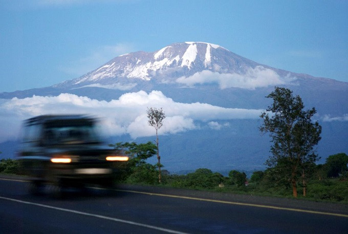 a vehicle drives past mount kilimanjaro in tanzania s hie district file reuters katrina manson