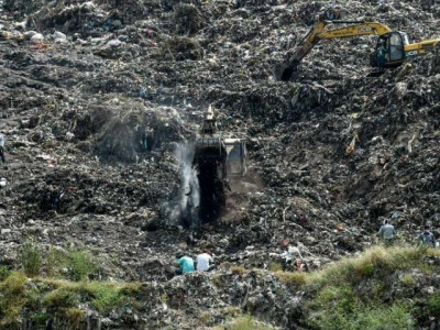 rescuers dig through indian trash dump for 12 year old rag picker