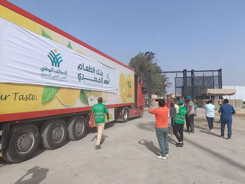 egyptian volunteers gather next to a truck carrying humanitarian aid as it drives through the rafah crossing from the egyptian side in rafah egypt october 22 2023 photo reuters