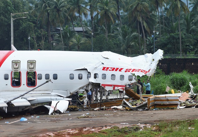 officials inspect the site where a passenger plane crashed when it overshot the runway at the calicut international airport in karipur in the southern state of kerala india august 8 2020 photo reuters