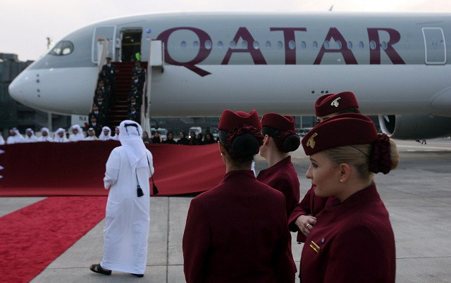 qatar airways cabin crew stand in front of an airbus a350 1000 at hamad international airport in doha qatar february 21 2018 photo reuters