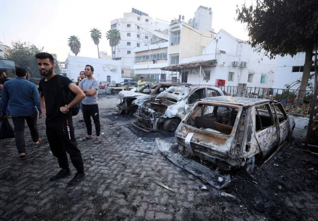 people inspect the area of al ahli hospital where hundreds of palestinians were killed in a blast in gaza city october 18 photo reuters