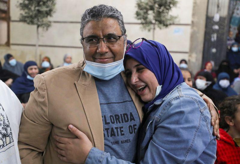 journalist mahmoud hussein embraces with his daughter after being released by egyptian authorities after four years in detention on accusations of publishing false news in abou al nomros in giza egypt february 6 2021 photo reuters