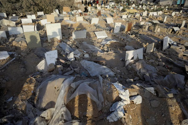 palestinians inspect damaged graves at al shifa hospital after israeli forces withdrew from the hospital and the area around it following a two week operation photo reuters