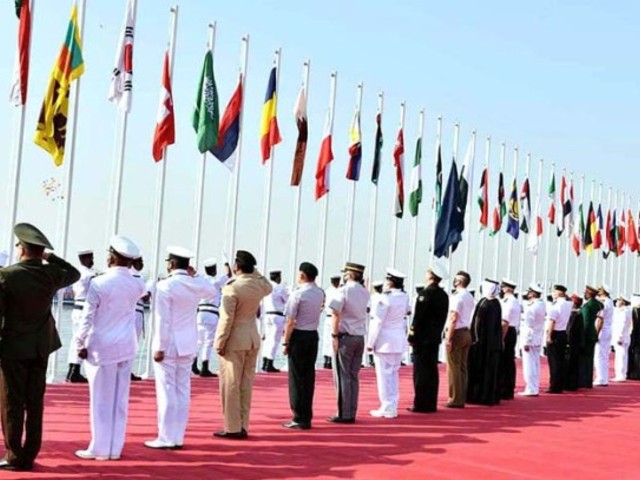 officials from international navy officials presenting salute during flags hosting ceremony of multinational naval exercise aman 2021 at pn dockyard photo app