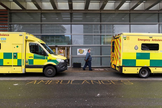 a man wearing a face mask amid the spread of the coronavirus disease covid 19 walks past the ambulances at the royal london hospital in london britain december 31 2021 photo reuters