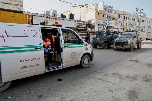 an ambulance blocked by israeli military vehicles during a raid in jenin in the israeli occupied west bank december 12 2023 photo reuters an ambulance blocked by israeli military vehicles during a raid in jenin in the israeli occupied west bank december 12 2023 photo reuters