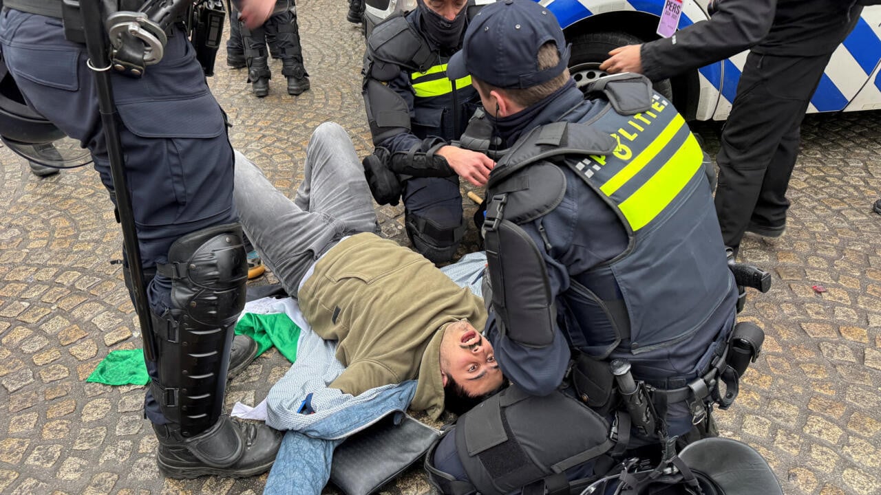 dutch police help a pro palestinian protester during a banned demonstration in amsterdam the netherlands on november 10 2024 photo reuters