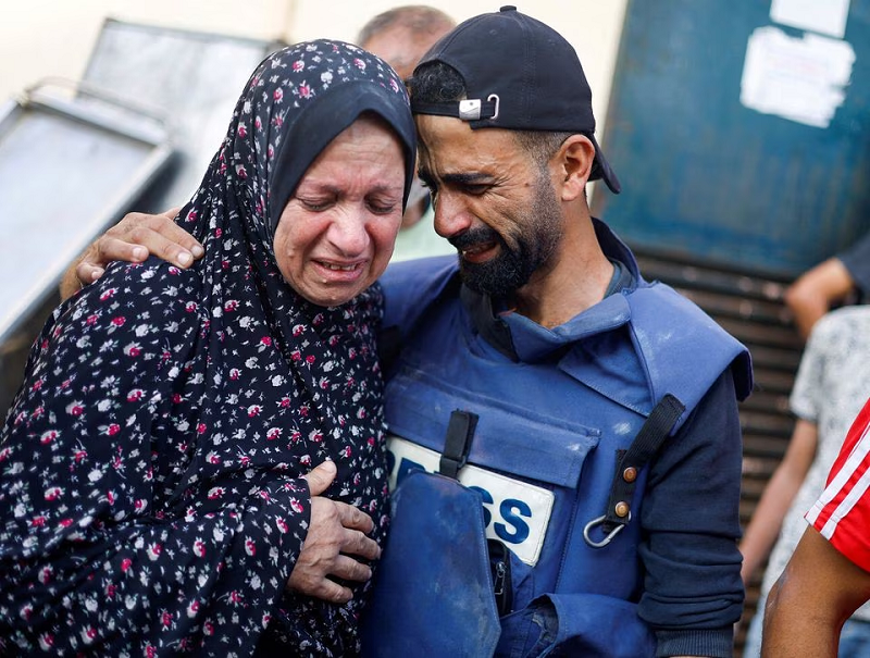 Anadolu Agency cameraman Mohammed El Aloul reacts after several of his children and siblings were killed in Israeli strikes at a hospital in the central Gaza Strip, November 5, 2023. PHOTO: REUTERS