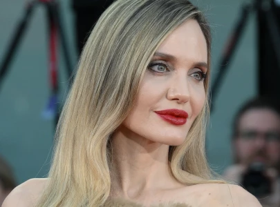 angelina jolie goes barefoot on the tonight show after breaking toe opens up about kids and rumors