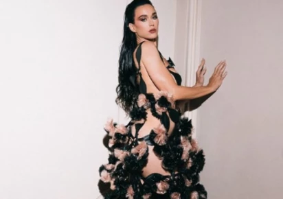 Katy Perry reveals Woman's World lyrics on dress train in Paris Katy Perry reveals Woman's World lyrics on dress train in Paris