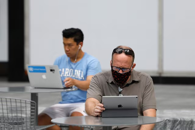 people use an apple laptop computer and an apple ipad in manhattan new york city us august 25 2020 photo reuters