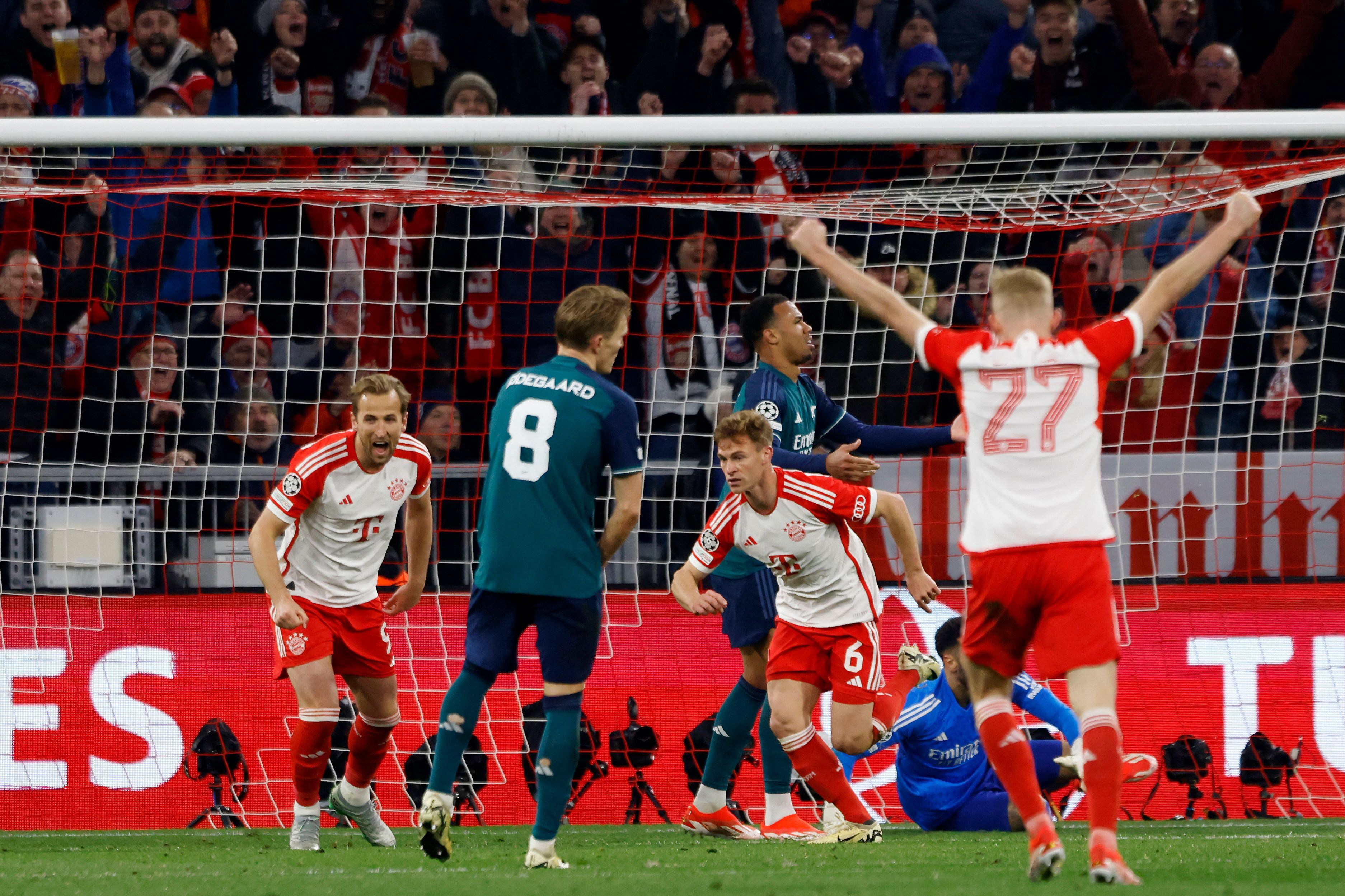 precious head   bayern munich s joshua kimmich 3l celebrates scoring the opening goal with teammates bayern munich s forward harry kane l and bayern munich s midfielder konrad laimer r during the uefa champions league quarter final second leg against arsenal fc in munich photo afp