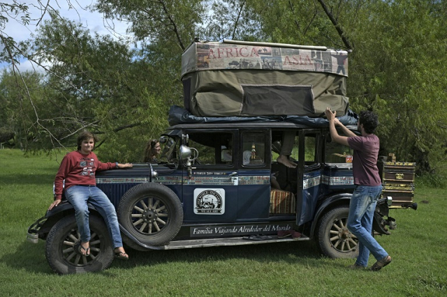 members of the zapp family of argentina open up a canvas that acts as a tent atop their 1928 graham paige car near gualeguaychu argentina on march 10 photo afp members of the zapp family of argentina open up a canvas that acts as a tent atop their 1928 graham paige car near gualeguaychu argentina on march 10 photo afp