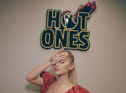 ariana grande takes on hot ones challenge comments on new album and wicked role